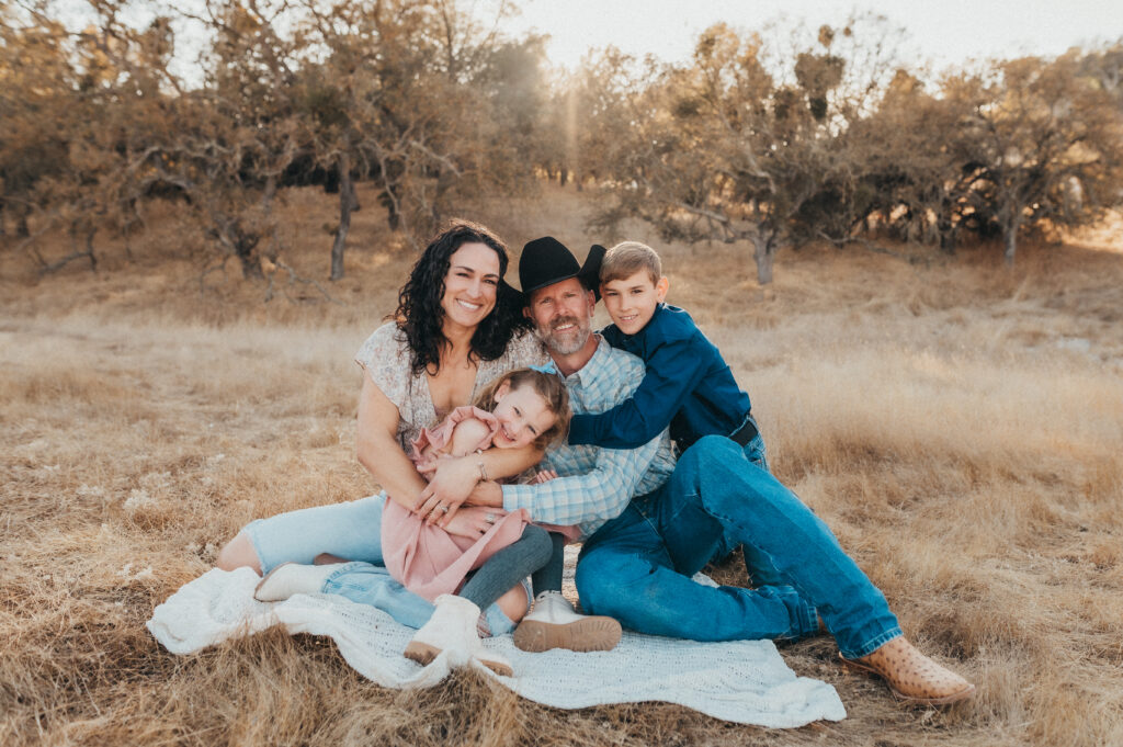 Family photo session in North County Paso Robles countryside with oak trees and golden sunset light