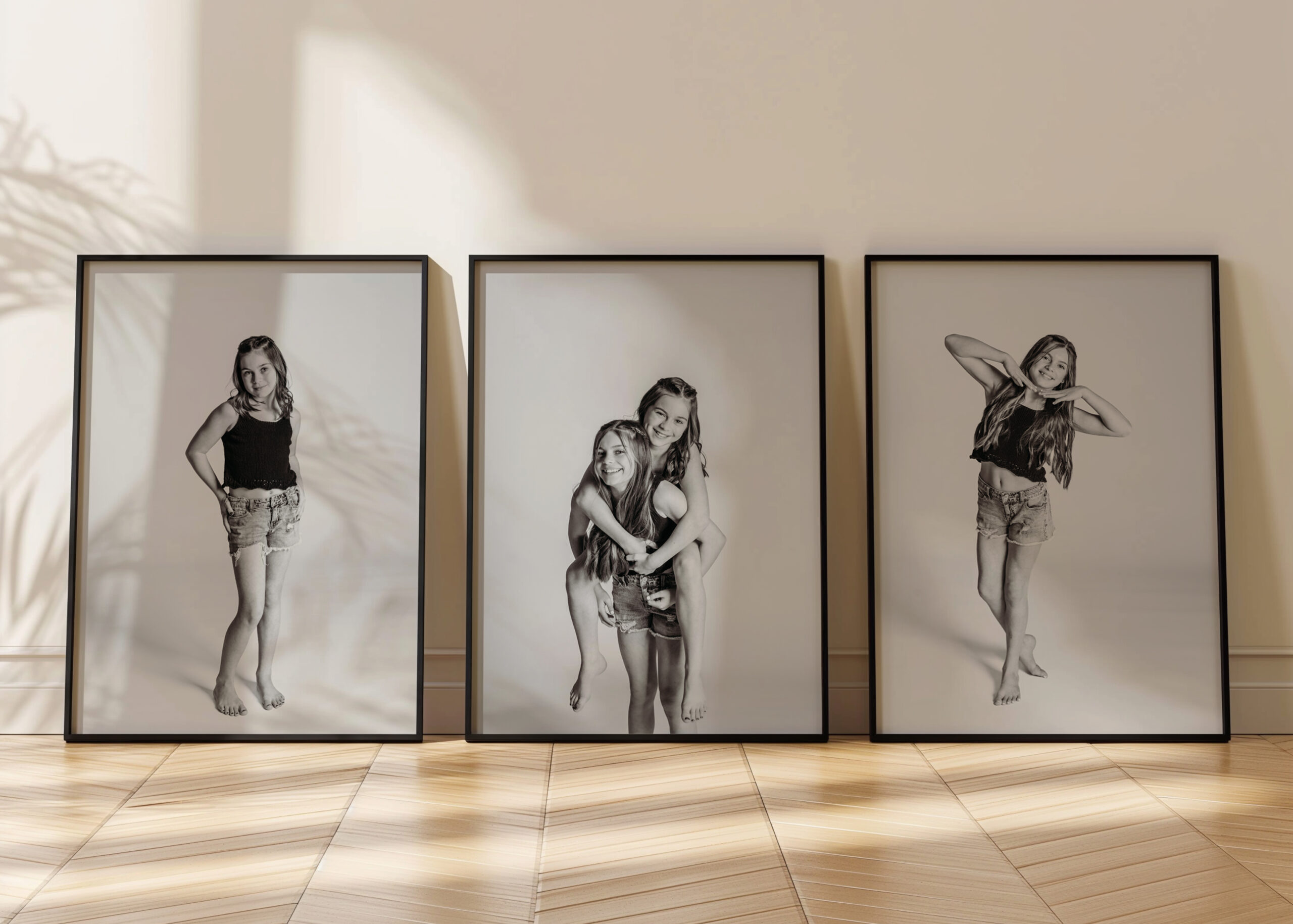 Three framed black and white personality portraits of children in studio, barefoot and smiling with playful poses